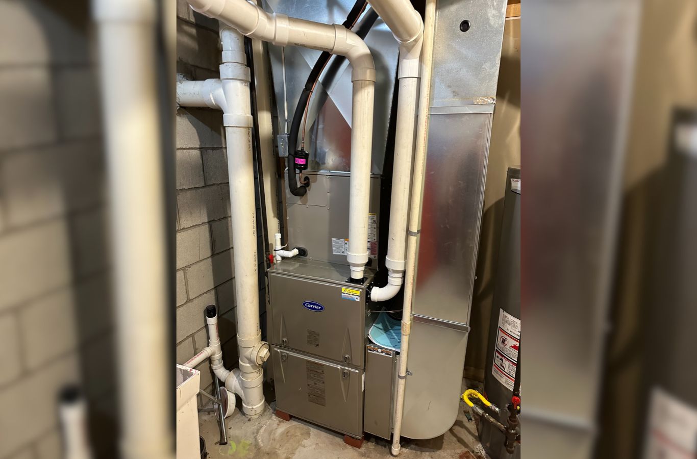 A Climate Systems Air Conditioning & Heating professional inspecting a furnace in Franklin Park, PA, delivering expert heating solutions.