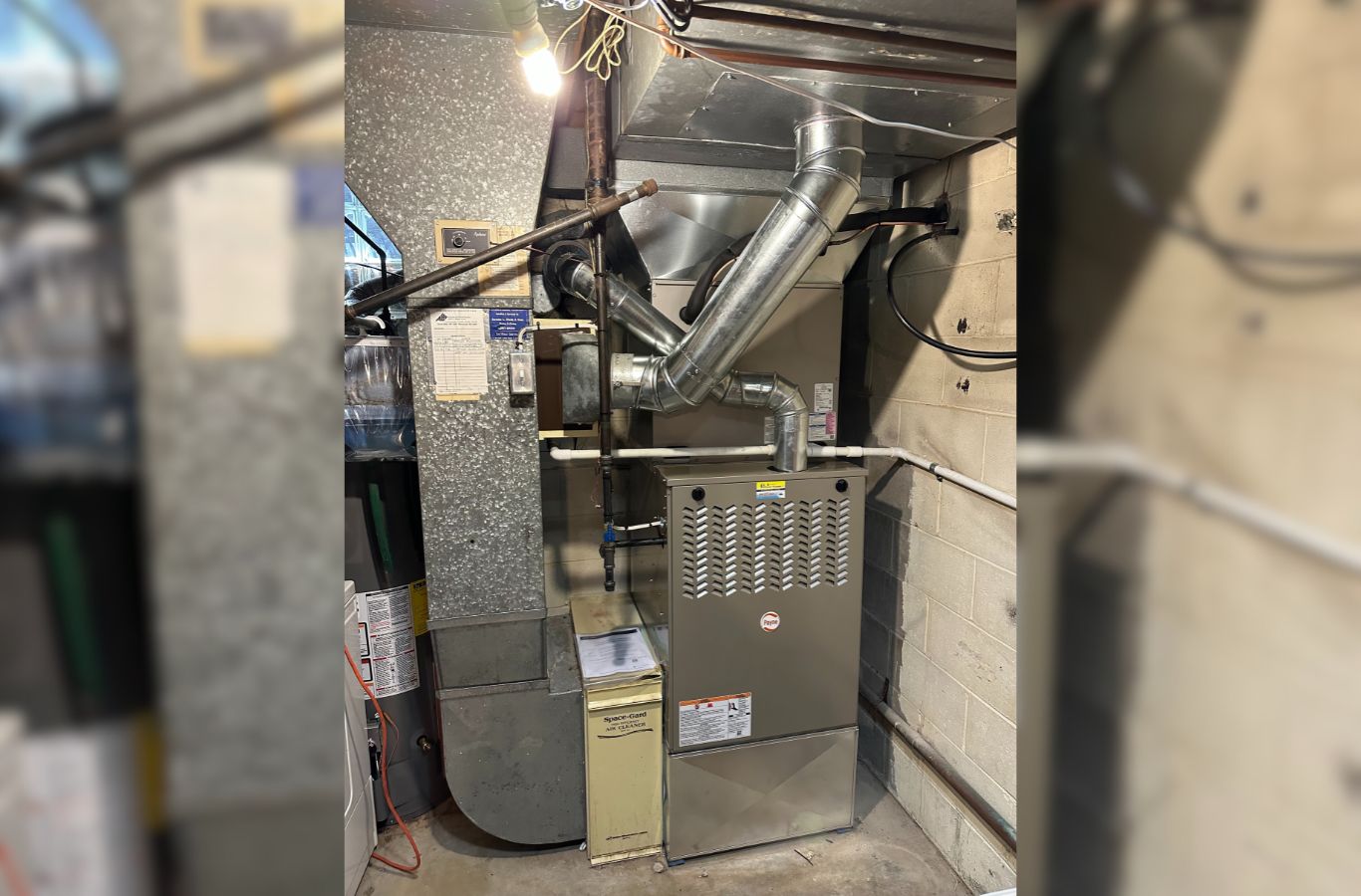 A Climate Systems Air Conditioning & Heating professional inspecting a furnace in McCandless, PA, delivering expert repair services.