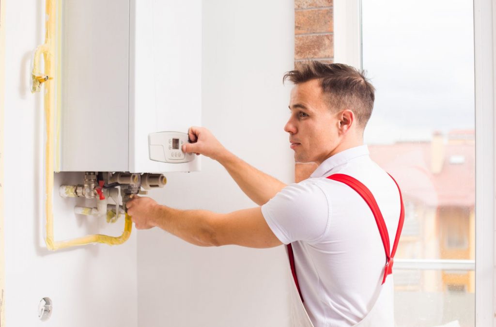 A Climate Systems technician repairing a boiler in Adams Township, PA, ensuring optimal heating performance for homeowners.