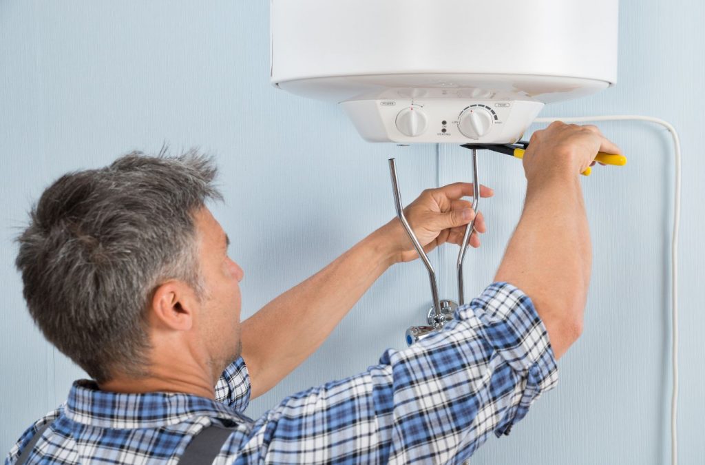 A Climate Systems technician performing a boiler repair in Allison Park, PA, ensuring reliable heating for a homeowner.