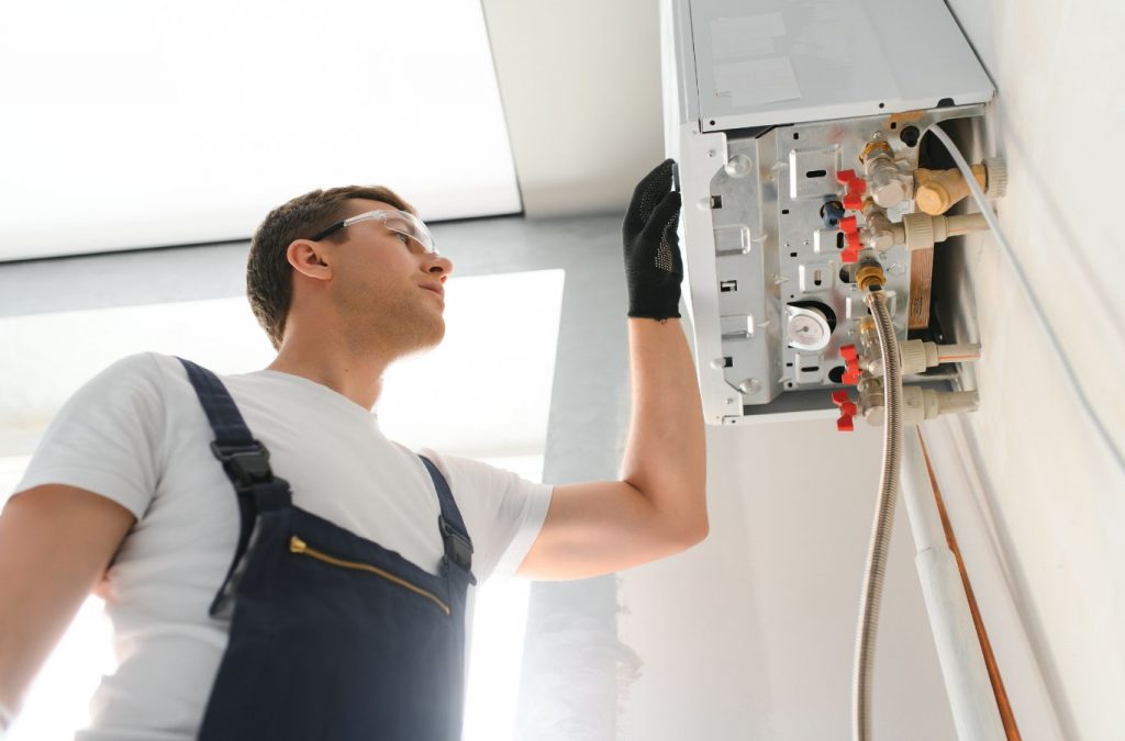 A Climate Systems technician inspecting a boiler in Cranberry Township, PA, ensuring proper function and efficiency.