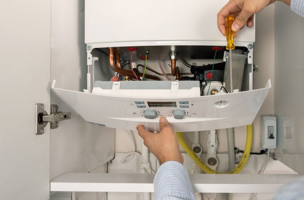 A Climate Systems technician diagnosing a boiler issue in Seven Fields, PA, ensuring efficient heating for a homeowner.